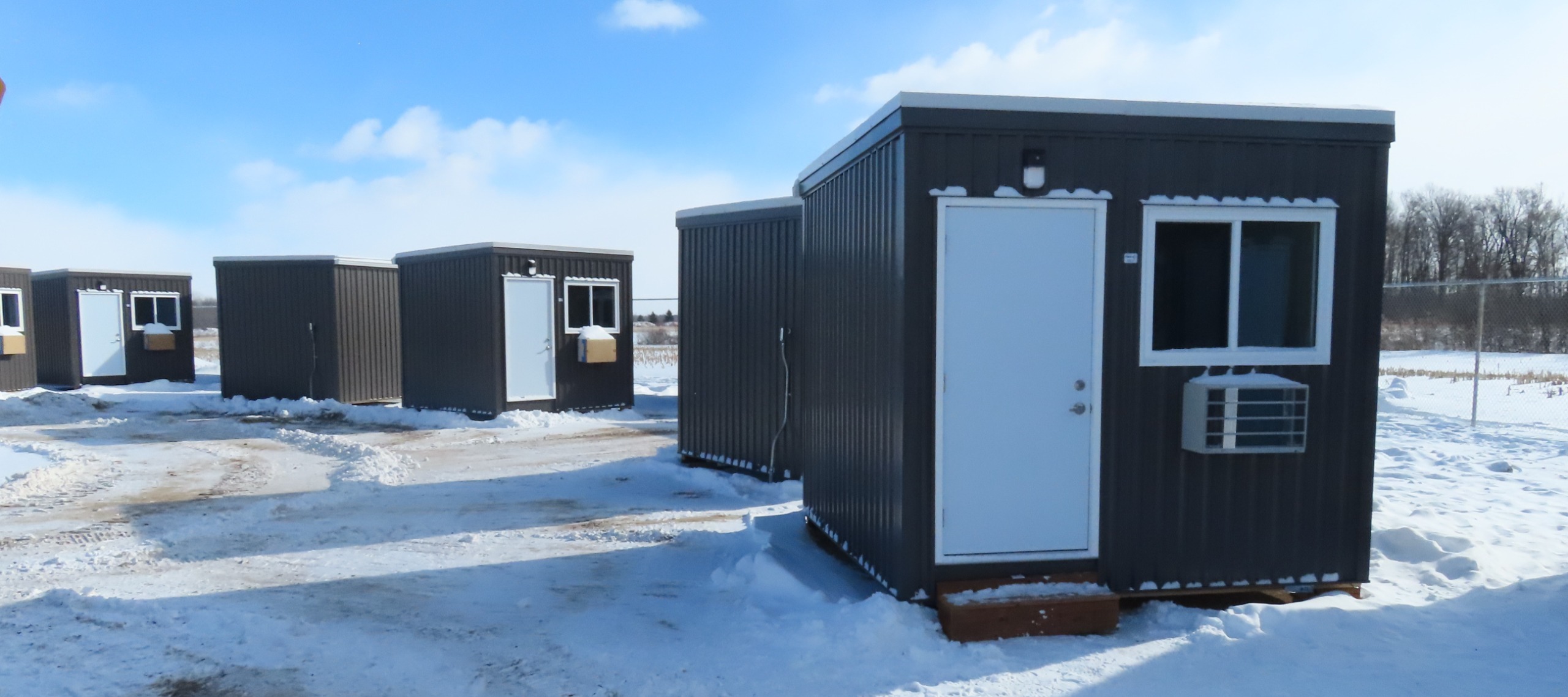 Shelter units at London’s Micro-Modular Shelter. Each unit includes electricity, heating and cooling, interior and exterior lighting, outlets for charging devices, fire-safety features, and a lockable door.
