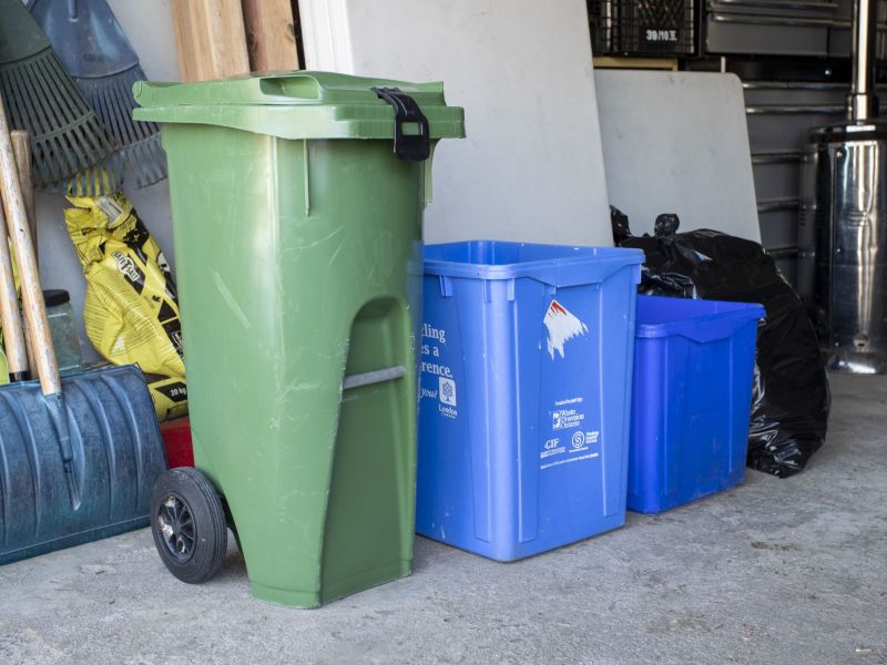 A medium size Green Bin in a garage